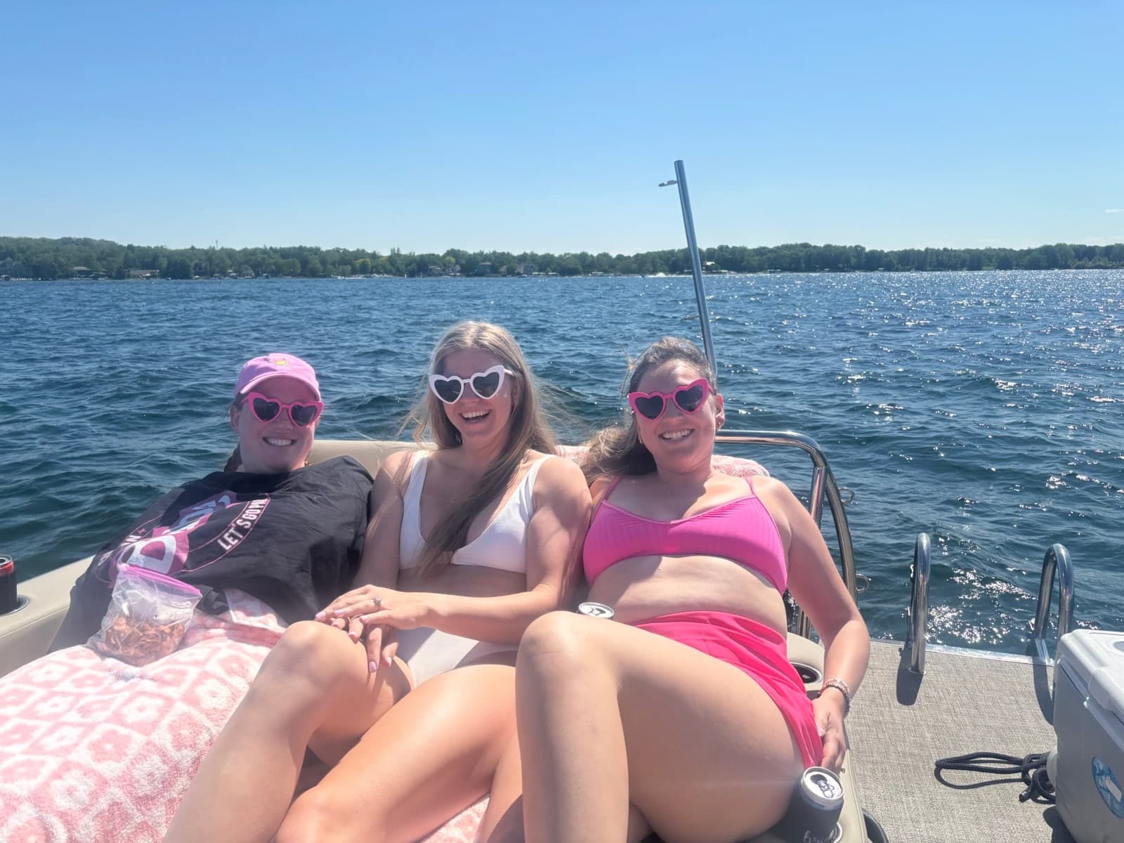 Three friends relaxing together on the back of the pontoon